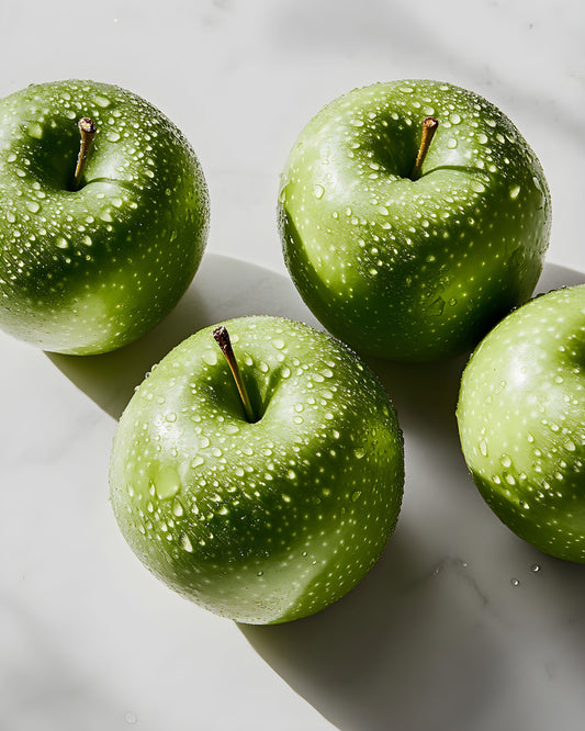 Fresh green apples with water droplets representing natural ingredients for apple cider vinegar and yogurt skincare
