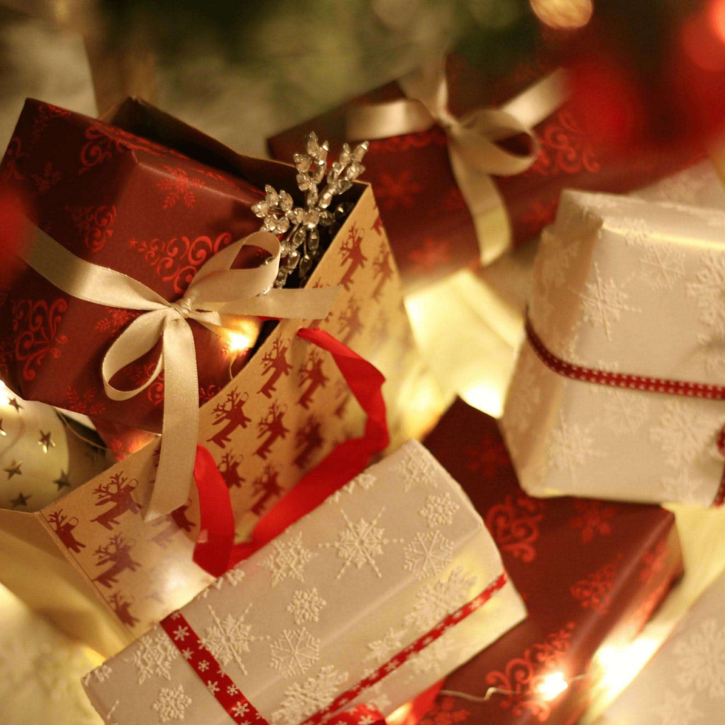 JOSSPURE handmade shea butter soap gift boxes with elegant red and white gift wrap and ribbons