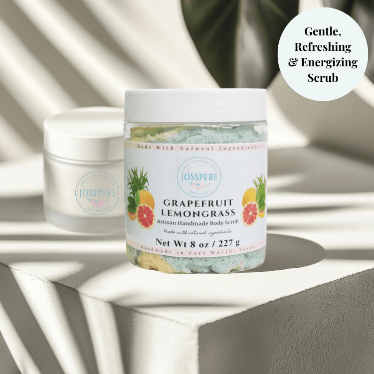JOSSPURE grapefruit orange luxury sugar scrub in clear jar with white lid on textured surface