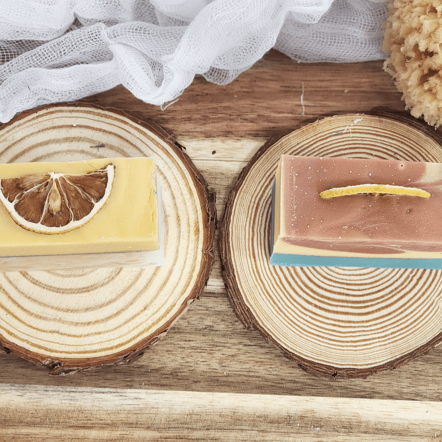 JOSSPURE lemongrass mild shea butter soap bar with dried lemon slice on wooden slice display