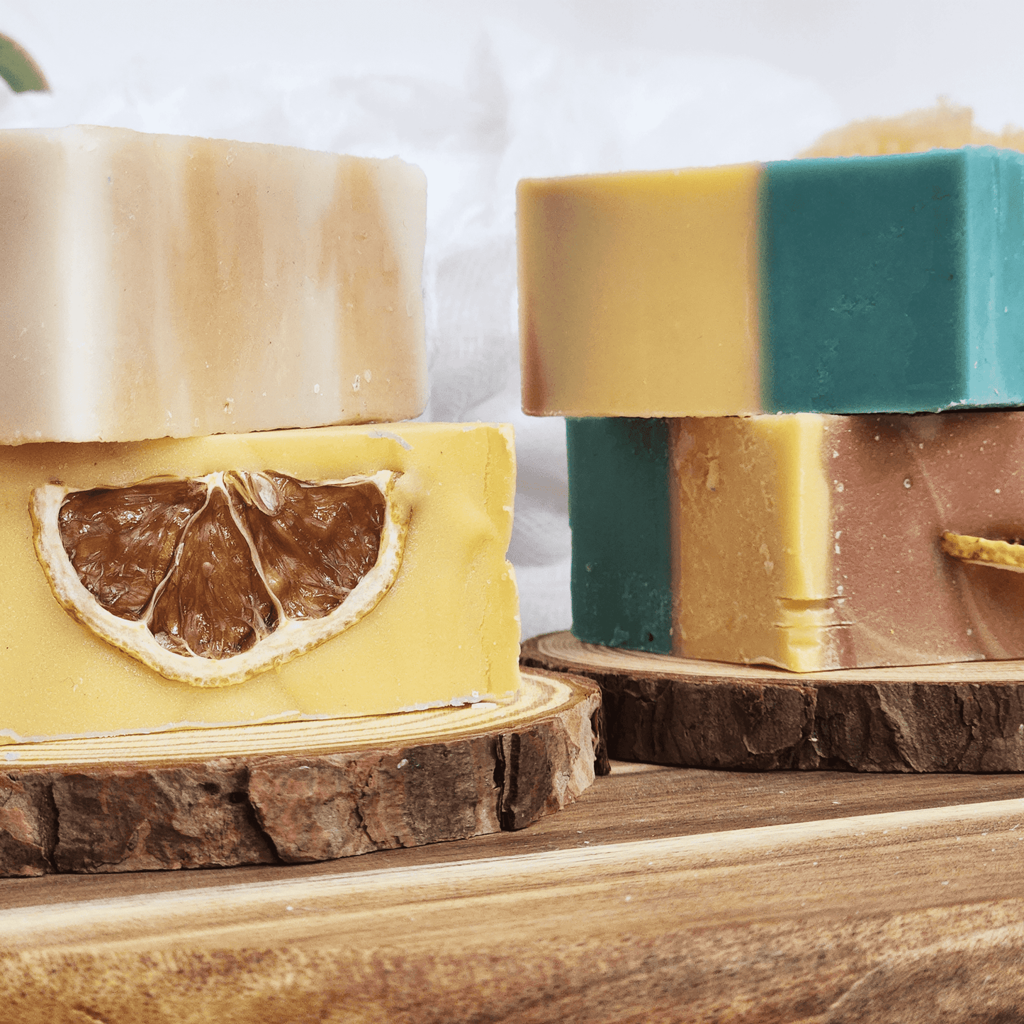 JOSSPURE handmade lemongrass mild shea butter soap bars with natural colors and dried lemon slice on wood