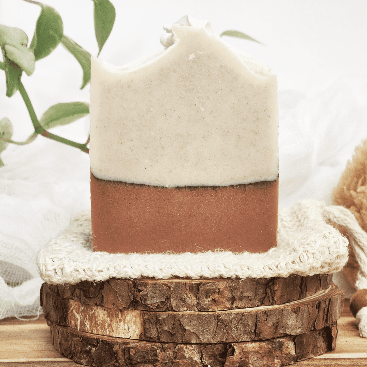 JOSSPURE handmade charcoal unisex soap with natural two-tone design on rustic wooden display