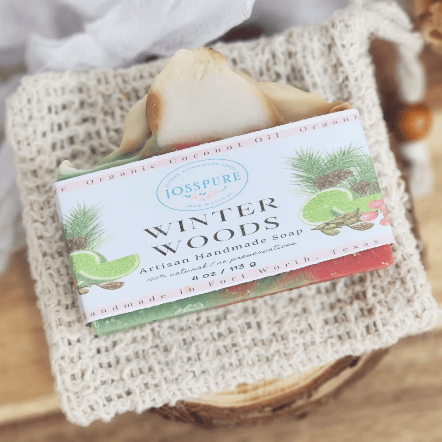 JOSSPURE Winter Woods artisan handmade Christmas mild shea butter soap with natural ingredients on a woven cloth