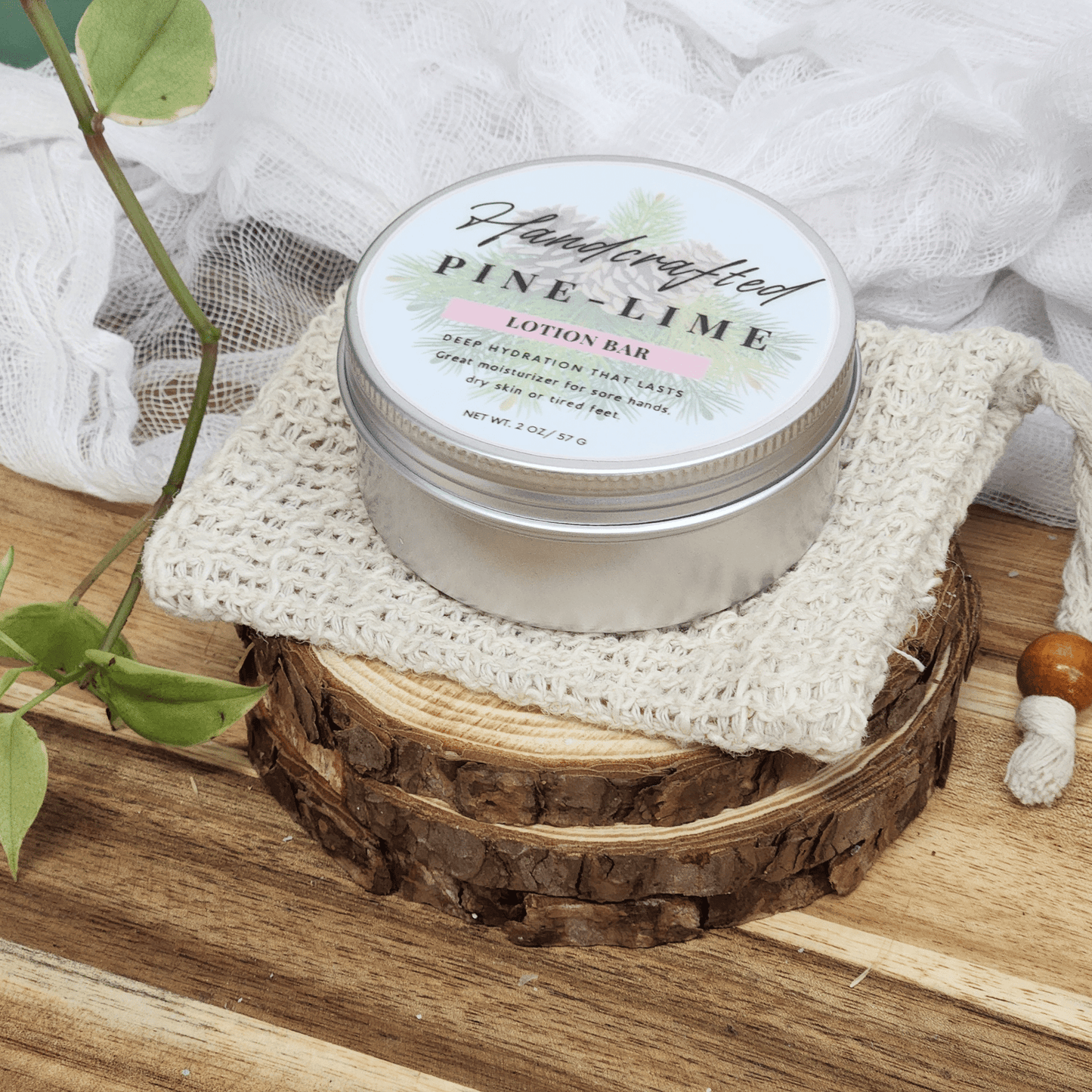 JOSSPURE handmade lotion bars pine lime scent in metal tin on natural wood and knitted cloth