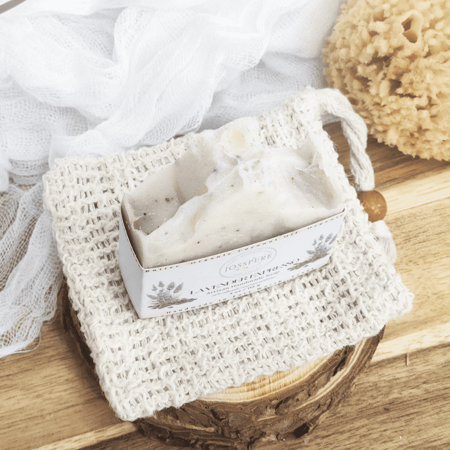 Lavender coffee mild shea butter soap bar by JOSSPURE on a textured soap pouch with natural bath sponge