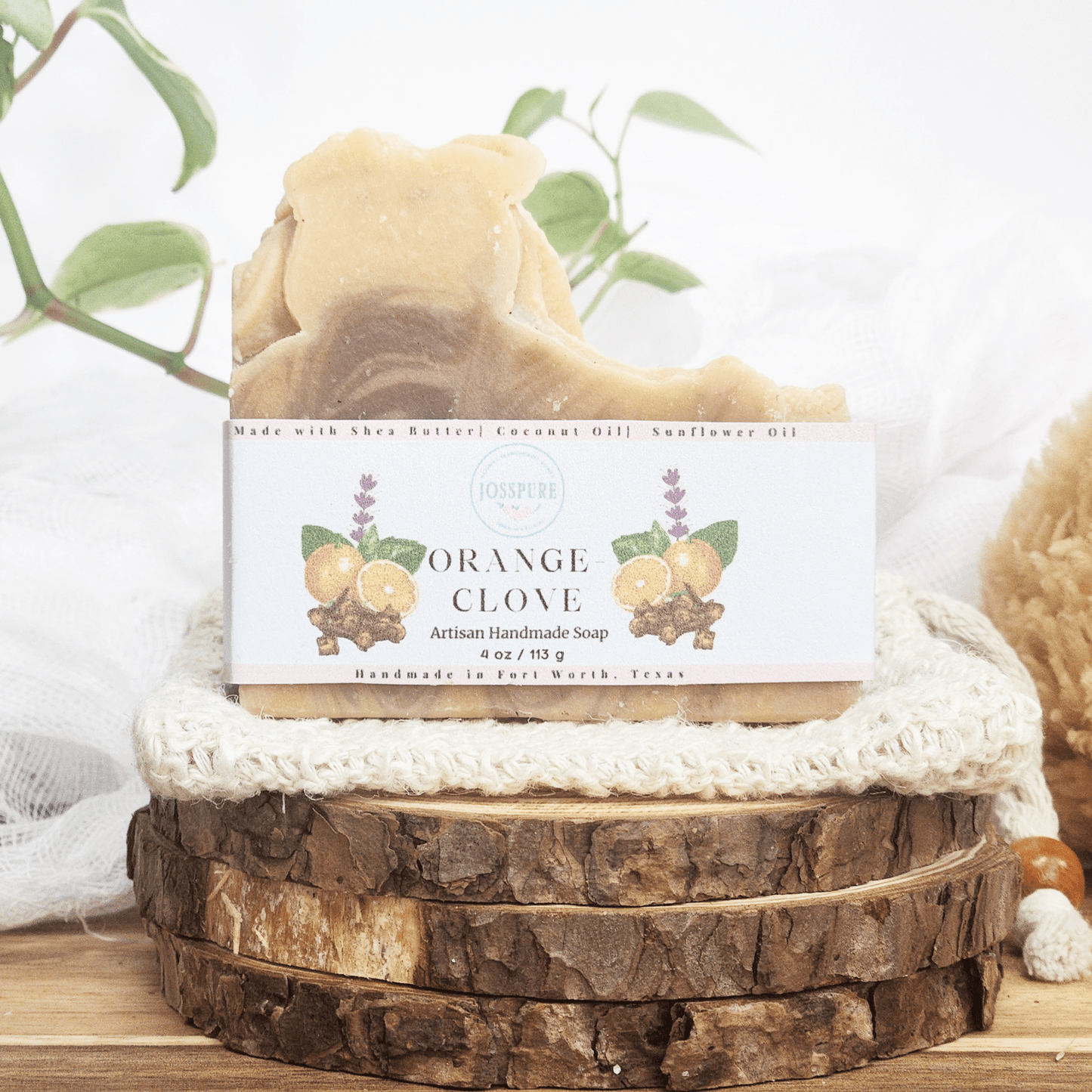 Orange clove patchouli mild shea butter soap handmade by JOSSPURE with natural ingredients on wooden display
