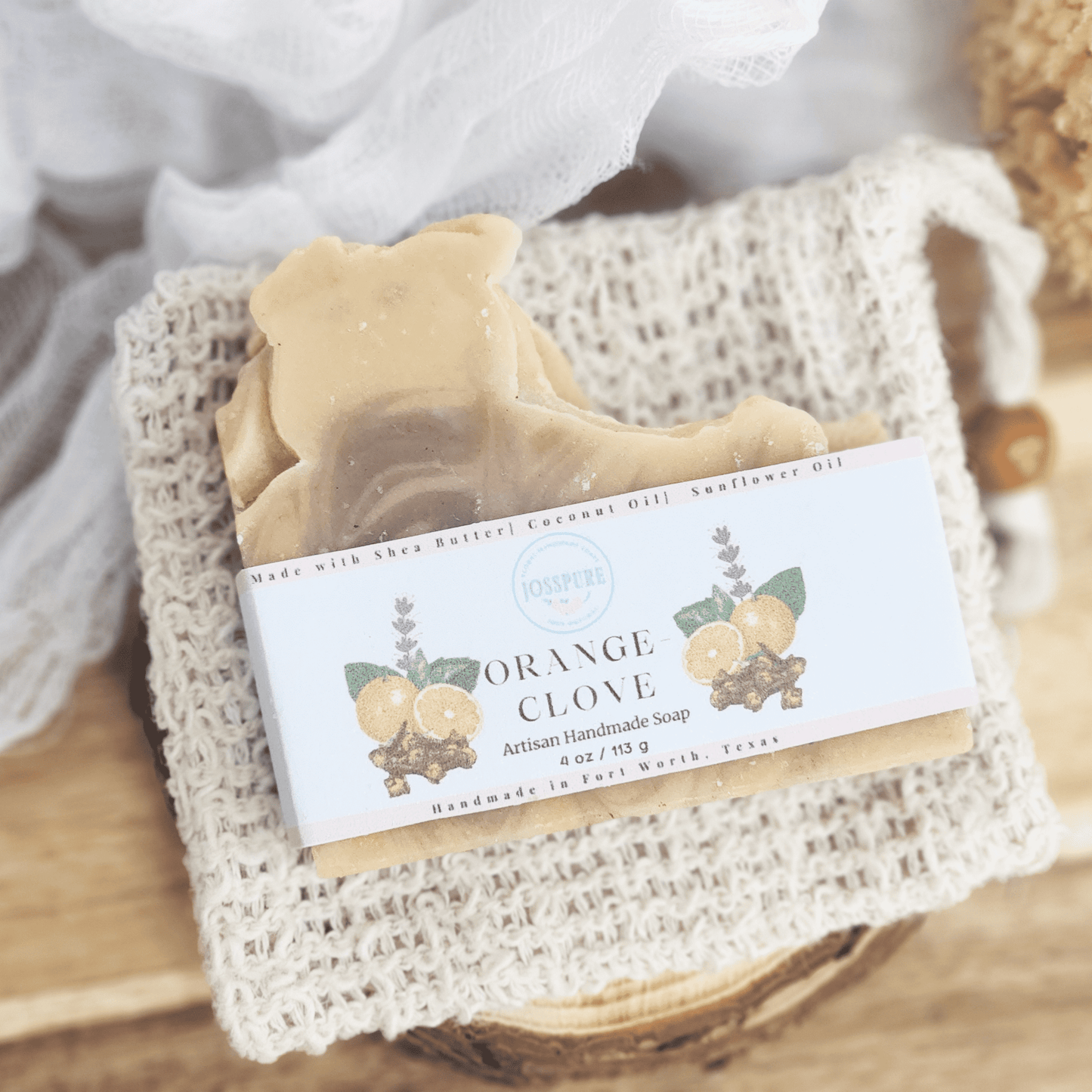 JOSSPURE orange clove patchouli mild shea butter soap handcrafted natural bar on a textured cloth
