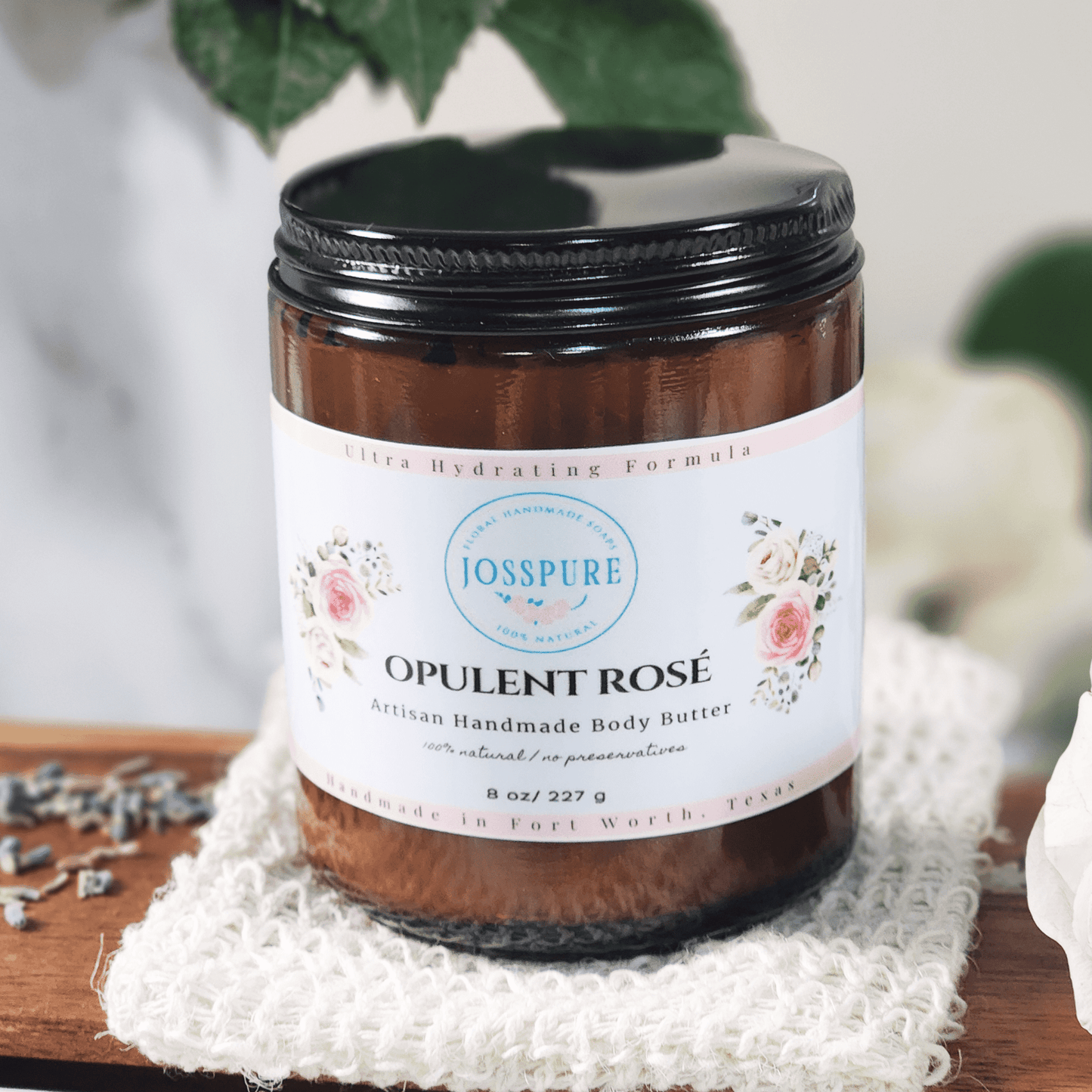 JOSSPURE rose mango butter whipped body butter in brown jar with floral label on white cloth