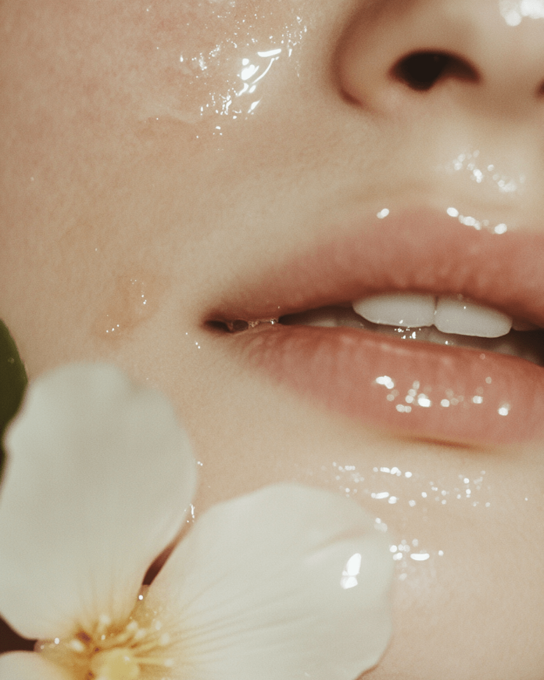 Close-up of smooth hydrated skin with natural flower illustrating cold process vs hot process soap benefits