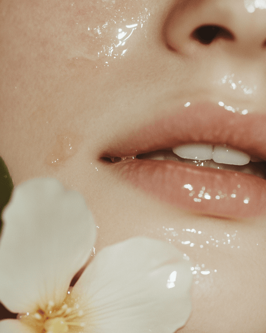 Close-up of smooth hydrated skin with natural flower illustrating cold process vs hot process soap benefits