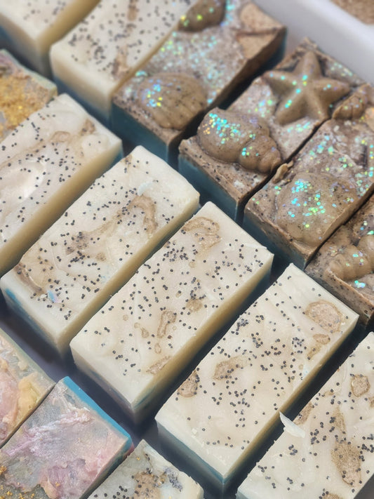Handmade soap bars with natural ingredients arranged in rows for soap challenge ocean soap collection