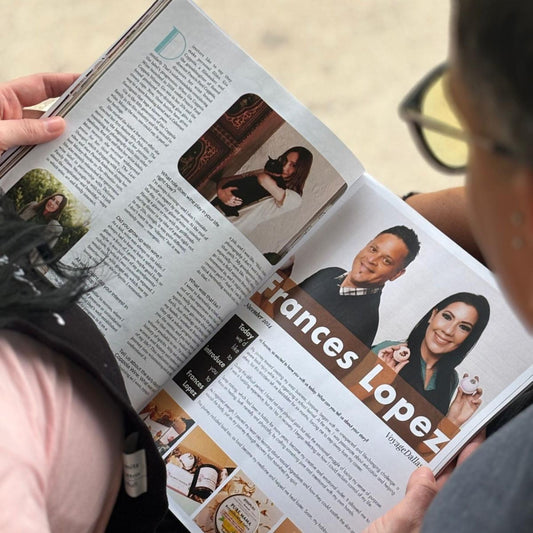 Person reading a magazine article about Josspure featured in voyage dallas magazine with images of founders and product shots
