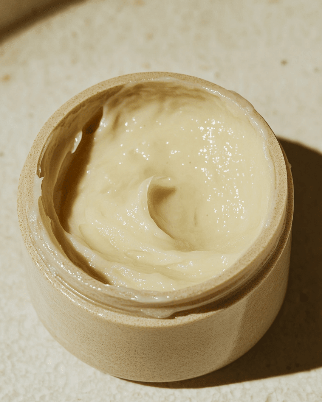 Jar of creamy shea butter showcasing shea butter benefits for dry sensitive skin with deep moisturizing properties