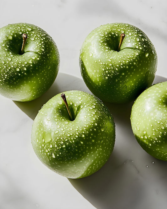 Fresh green apples with water droplets representing natural ingredients for apple cider vinegar and yogurt skincare