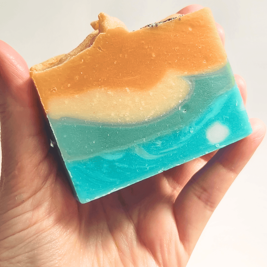 Colorful handmade soap bar with ocean waves design, part of a guide to handmade soap