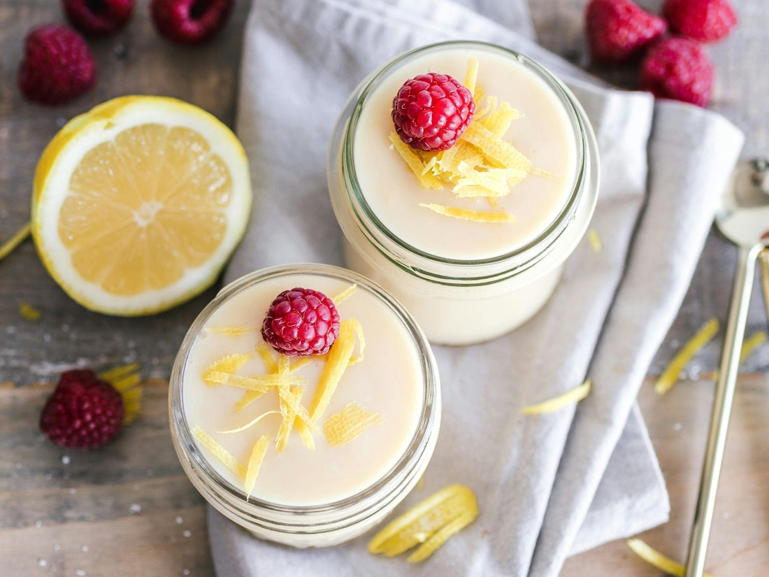 Creamy yogurt skincare jars topped with raspberries and lemon zest showcasing yogurt in skincare benefits