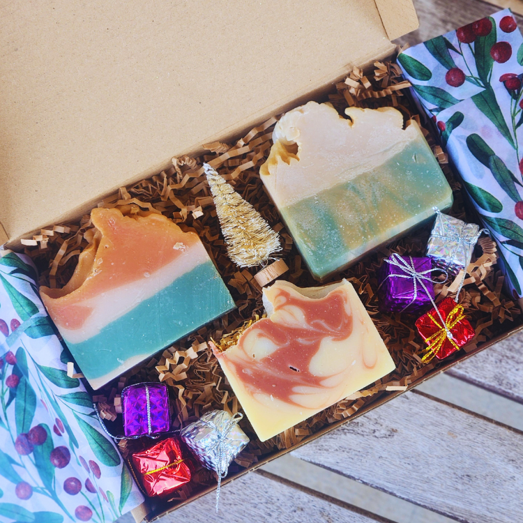 Woman enjoying a refreshing cleanse with Artisan Shea Butter Christmas Soaps, creating a bubbly lather