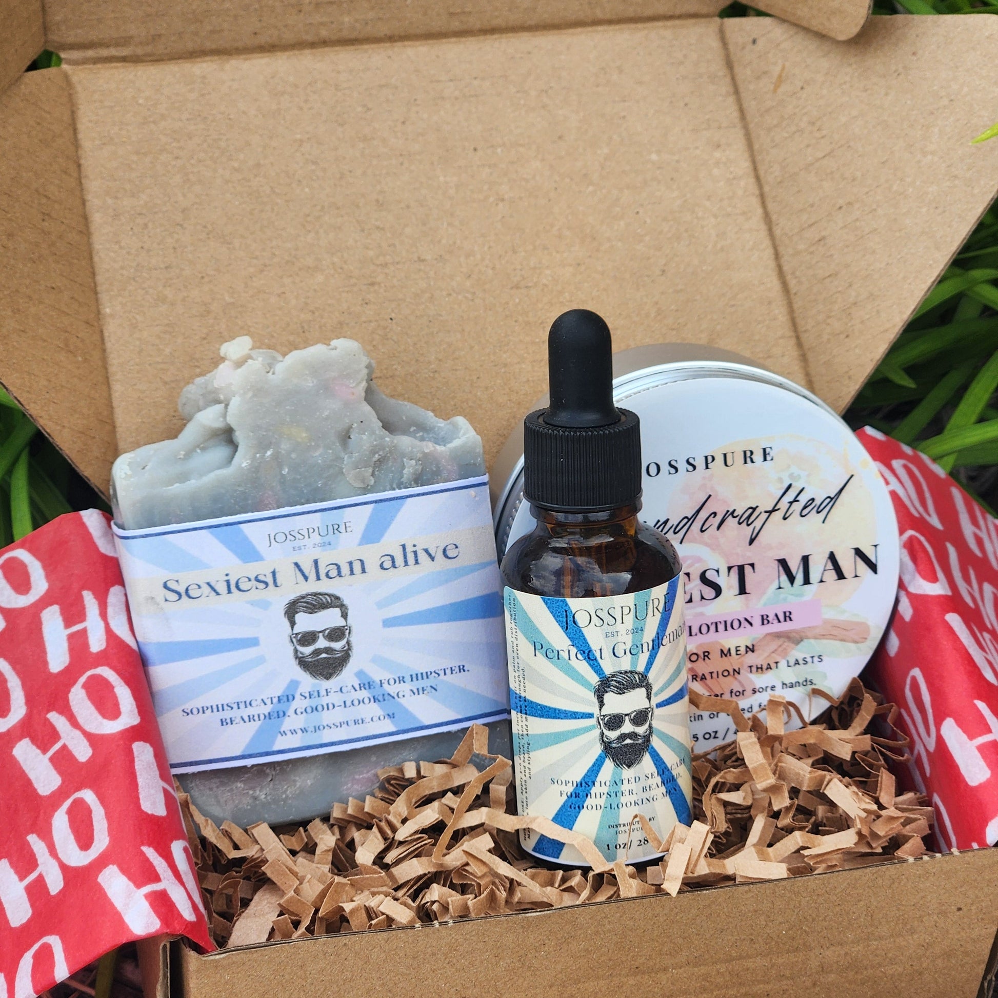 Product packaging with a bottle, soap, and other items inside a cardboard box.