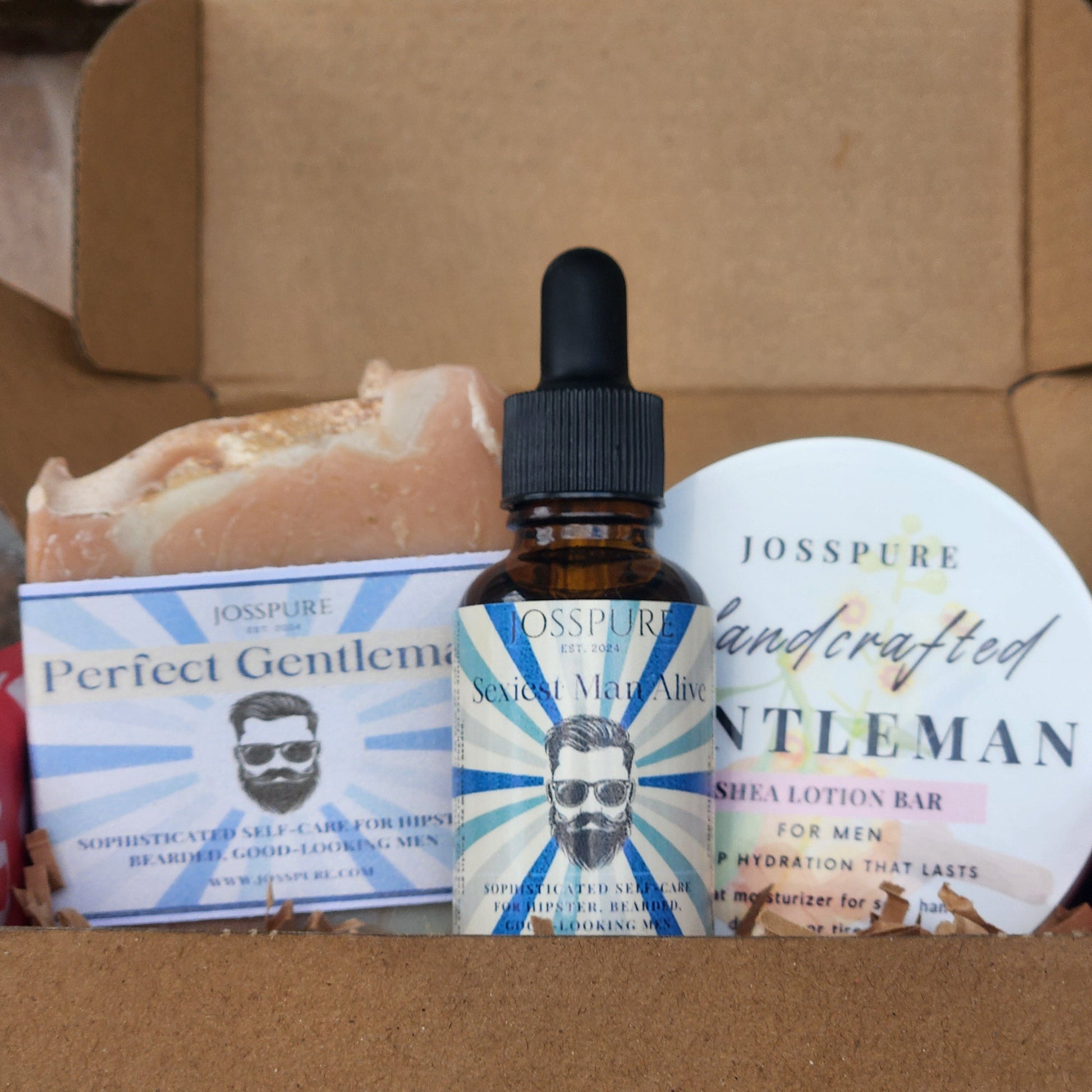 Assorted grooming products including a bottle with a dropper, a tube, and a bar of soap on a cardboard surface.
