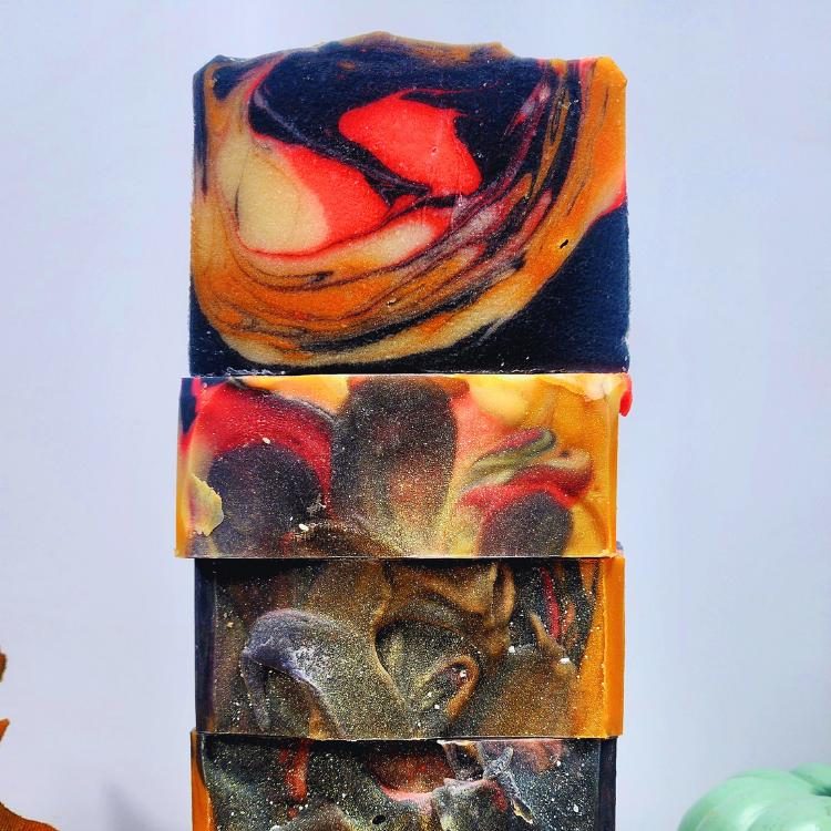 Stack of JOSSPURE handmade bonfire fall soap bars featuring rich, swirled colors for a seasonal touch