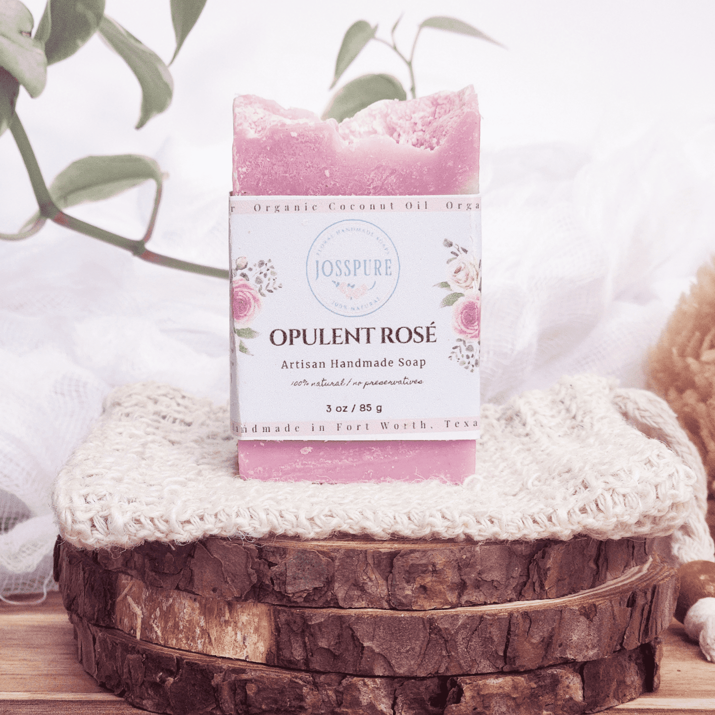 Travel Size Mild Shea Butter Soap Opulent Rosé handmade by JOSSPURE displayed on rustic wooden slices