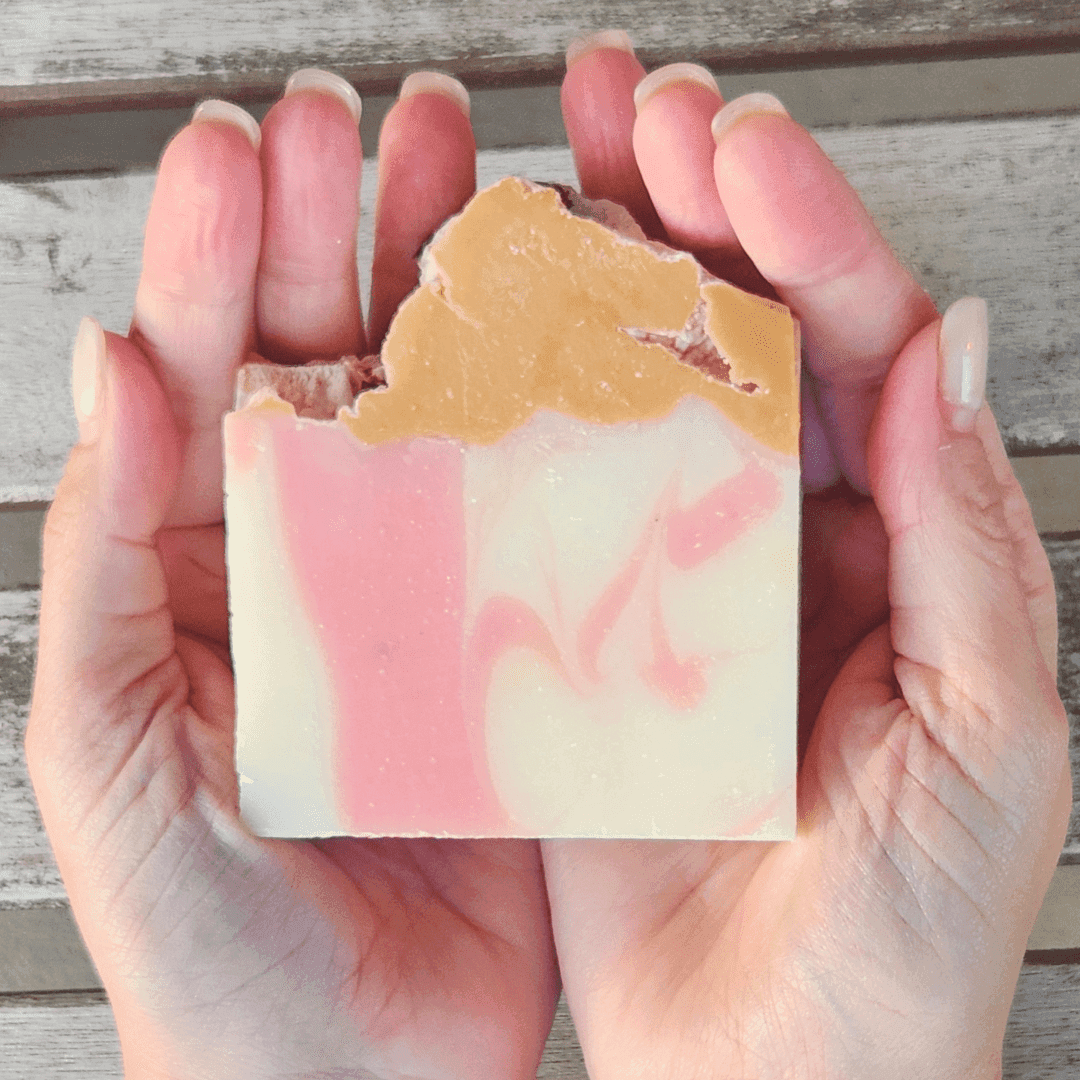 Champagne dreams shea butter soap displayed in hands with elegant swirls and colors