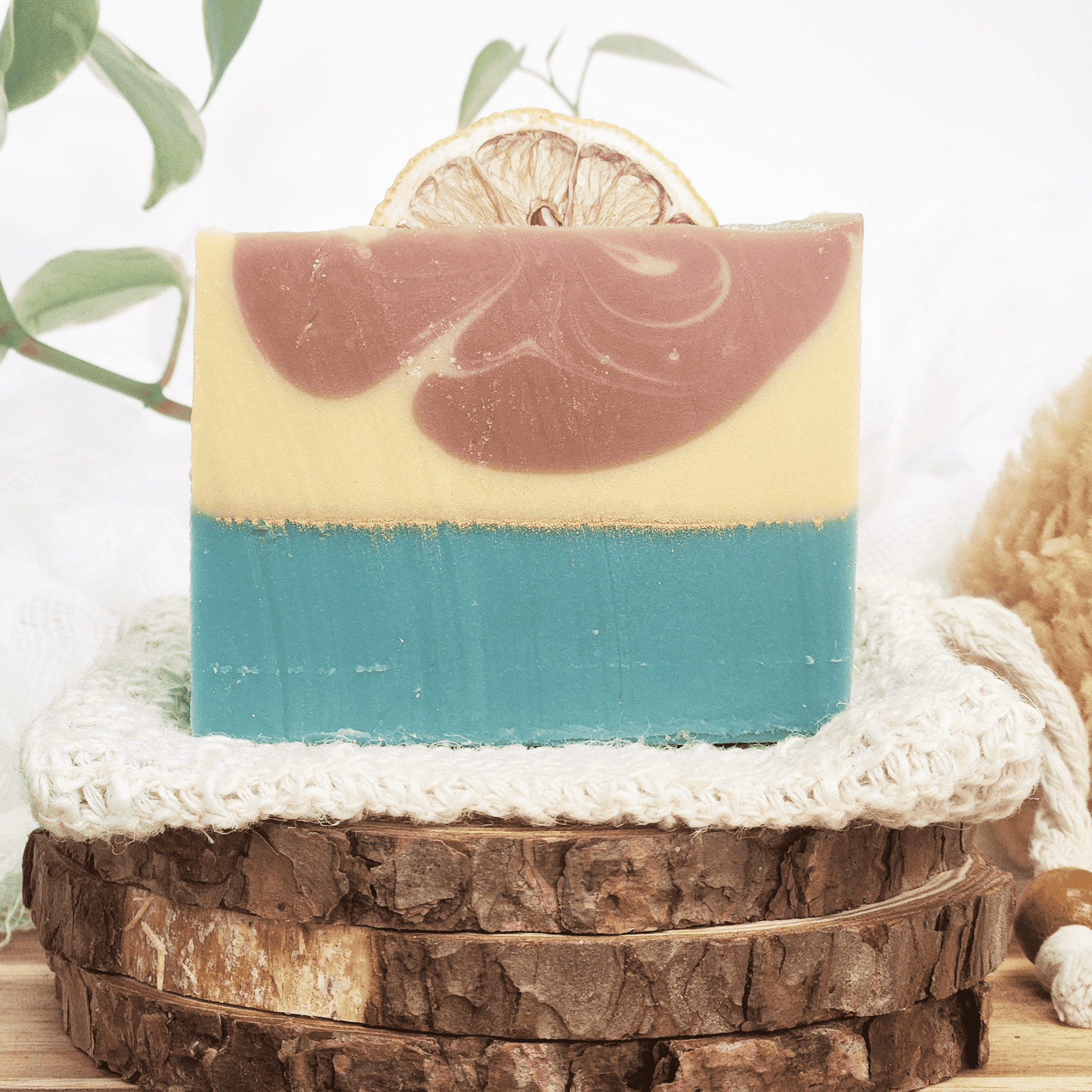 JOSSPURE handmade lemongrass mild shea butter soap with layered colors and natural dried lemon slice