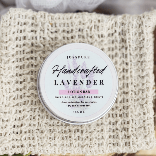 JOSSPURE lavender travel size mini lotion bar in a round tin on a textured cloth background