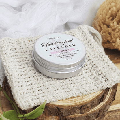 JOSSPURE lavender travel size mini lotion bar in metal tin on textured cloth with natural bath sponge