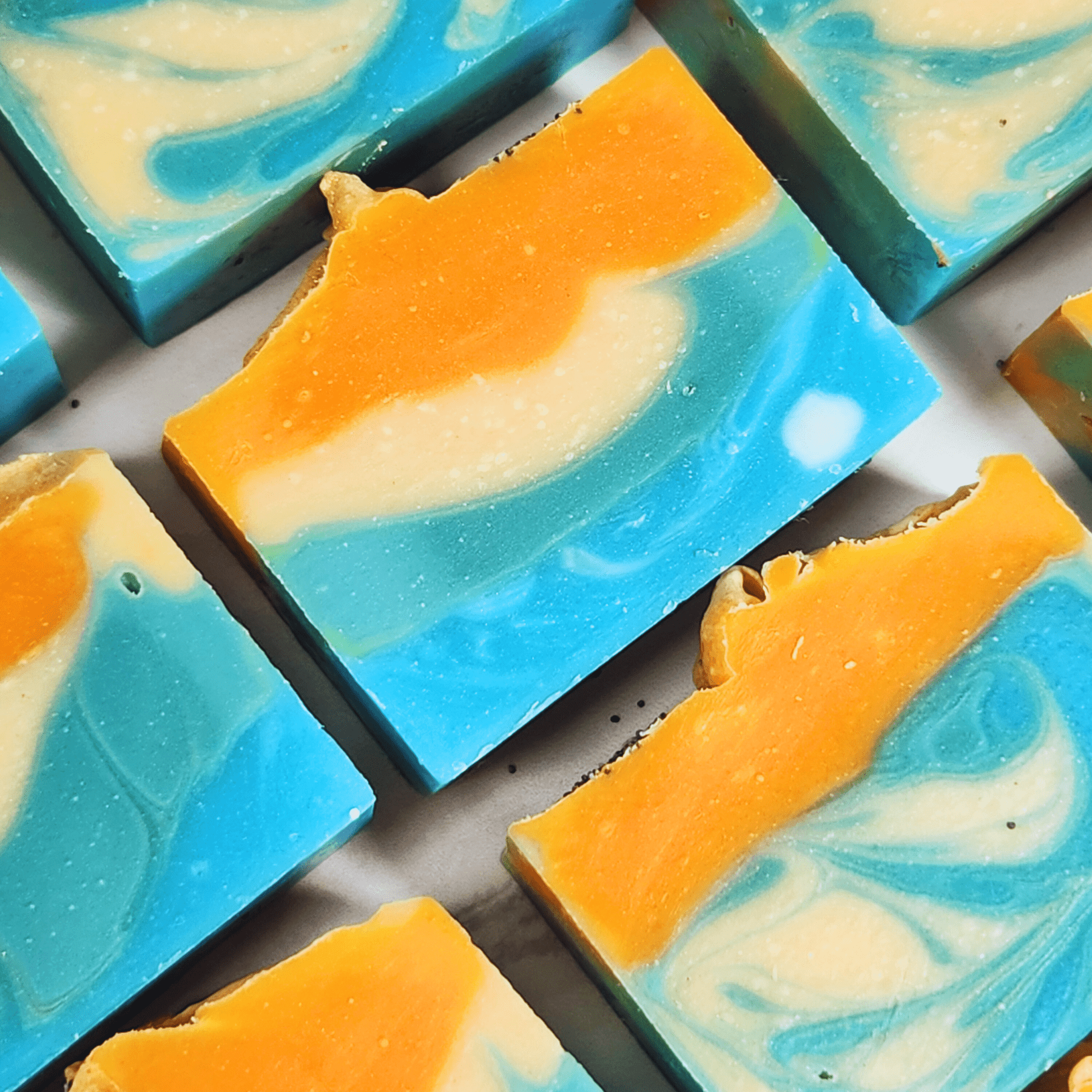 JOSSPURE handmade mango papaya shea butter soap bars with vibrant orange and blue swirls