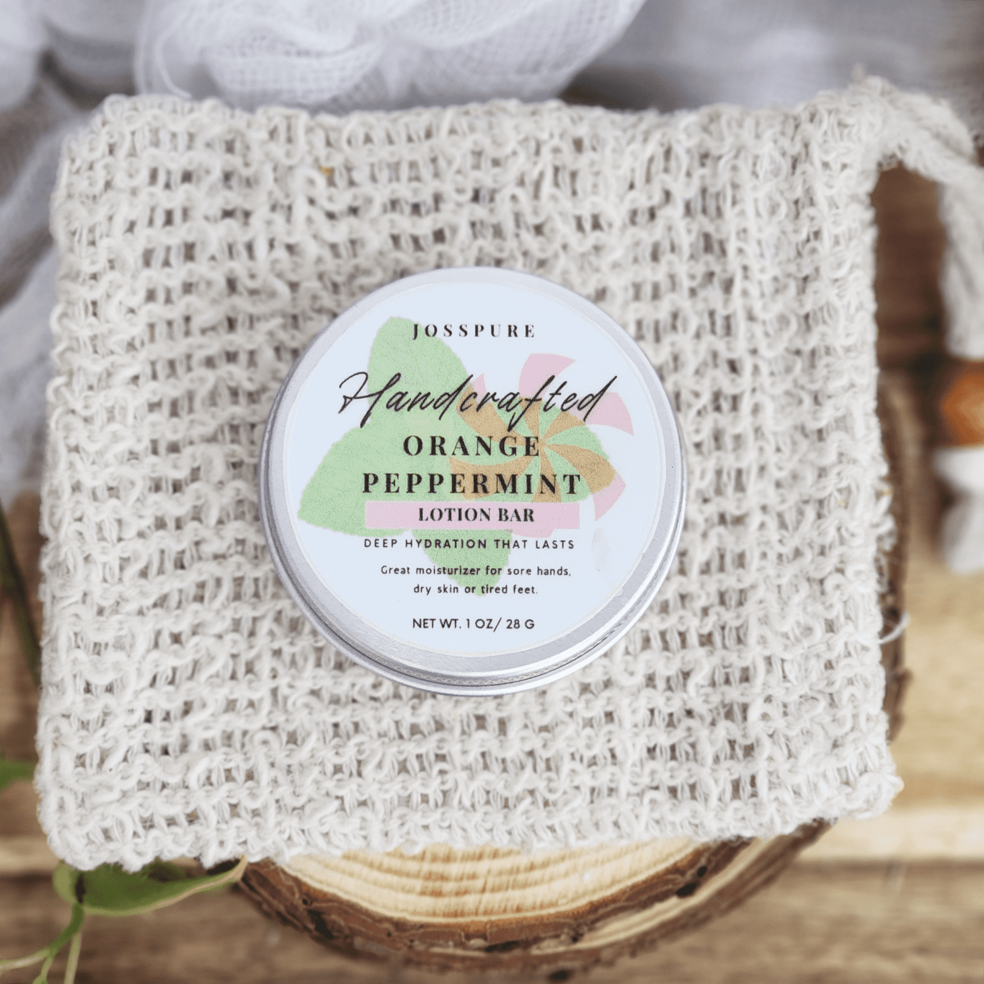 JOSSPURE peppermint orange Travel size mini lotion bar in a round tin on a woven natural cloth