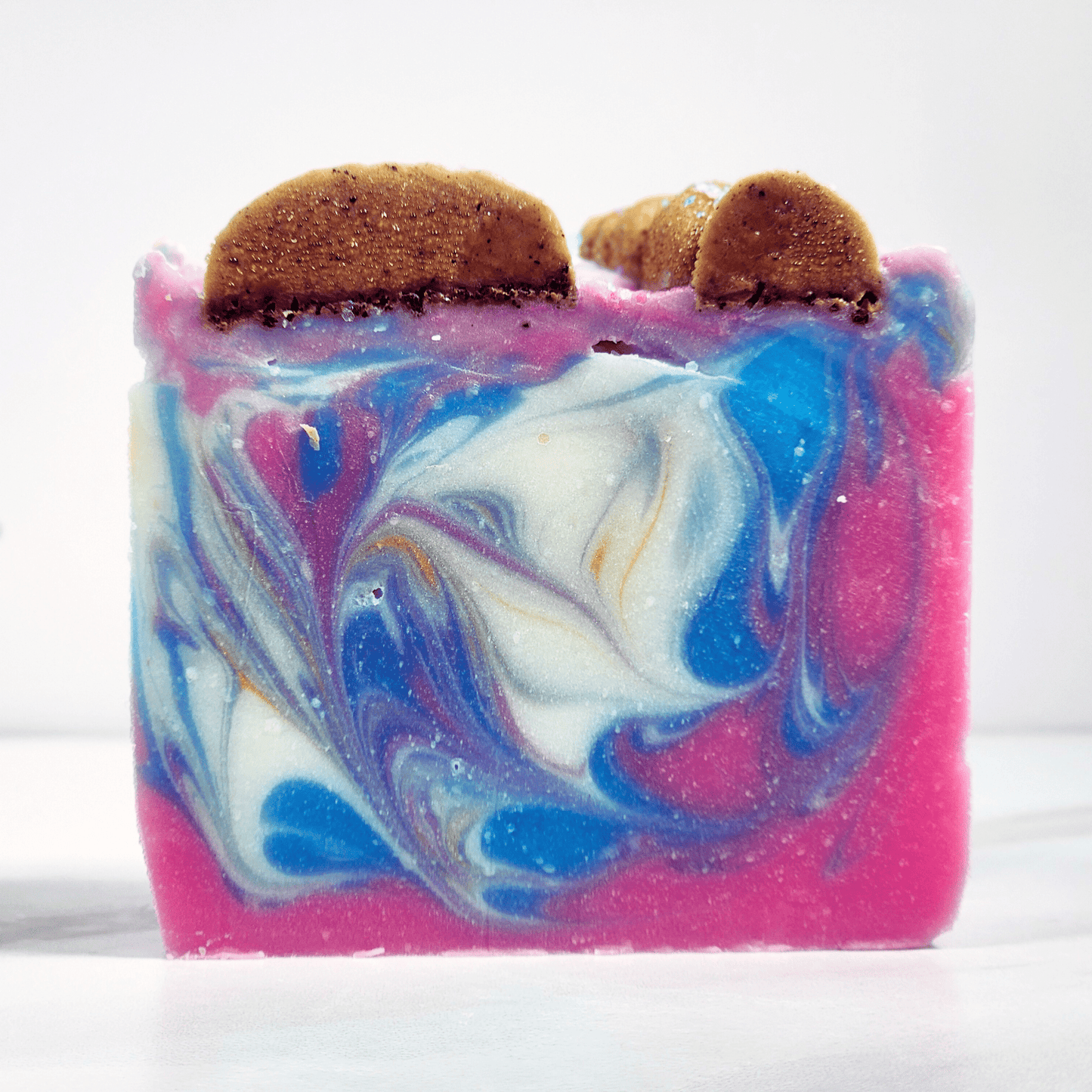 JOSSPURE handmade sea salt shea butter summer soap with vibrant blue white and pink swirls and brown textured top