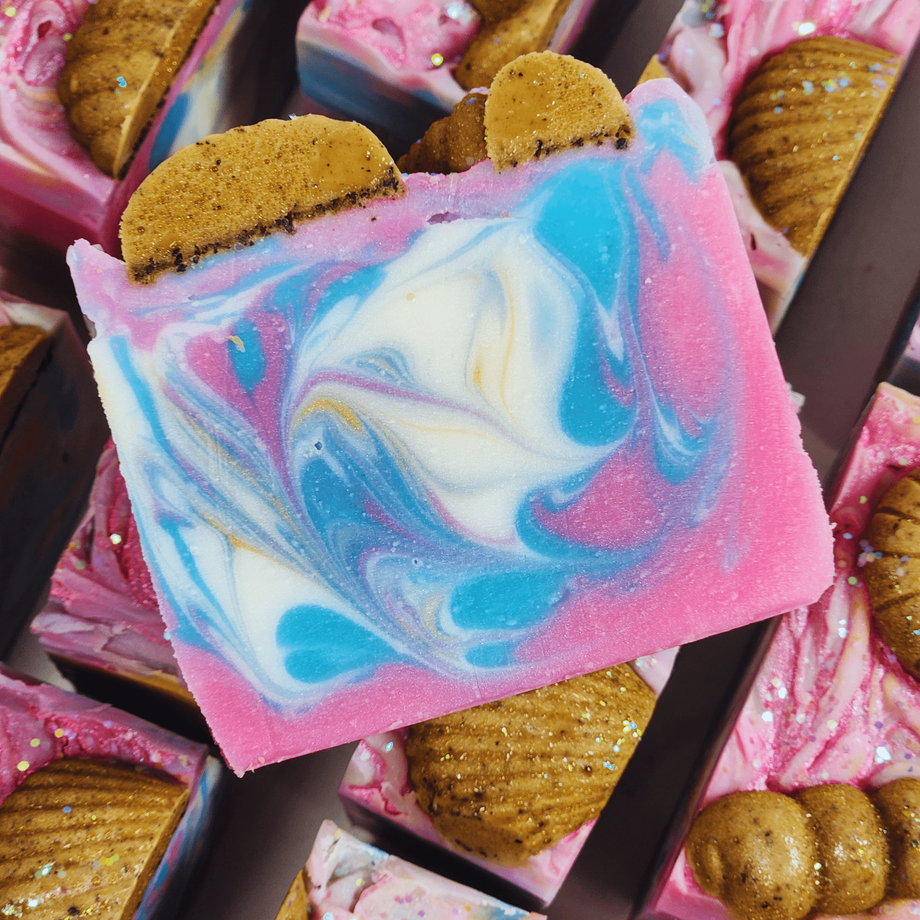 Handmade sea salt shea butter summer soap with colorful swirls and decorative brown accents