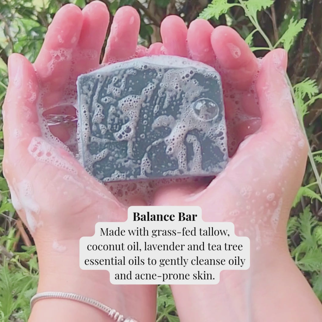 balance bar made with activated charcoal bubbling on top of two hands