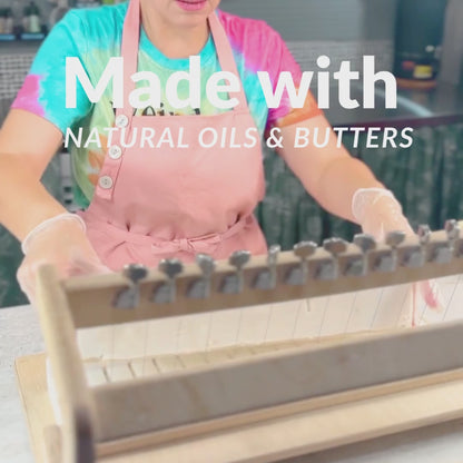 soapmaker cutting a soap loaf