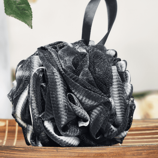 Black and white recycled eco friendly bath sponge hanging with textured soft mesh material