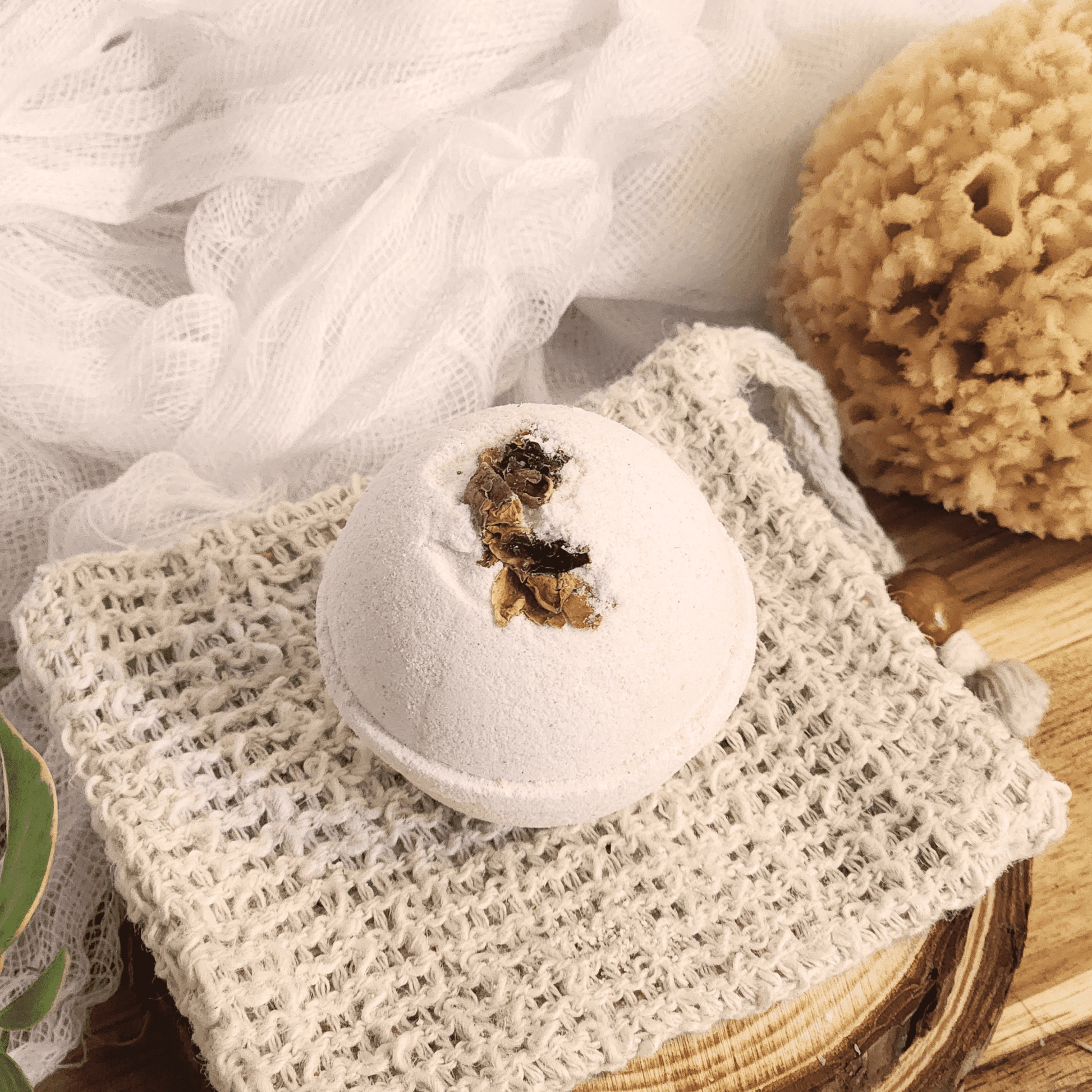 Rose luxury bath bomb with dried flower petals on woven cloth by natural sponge and soft fabric