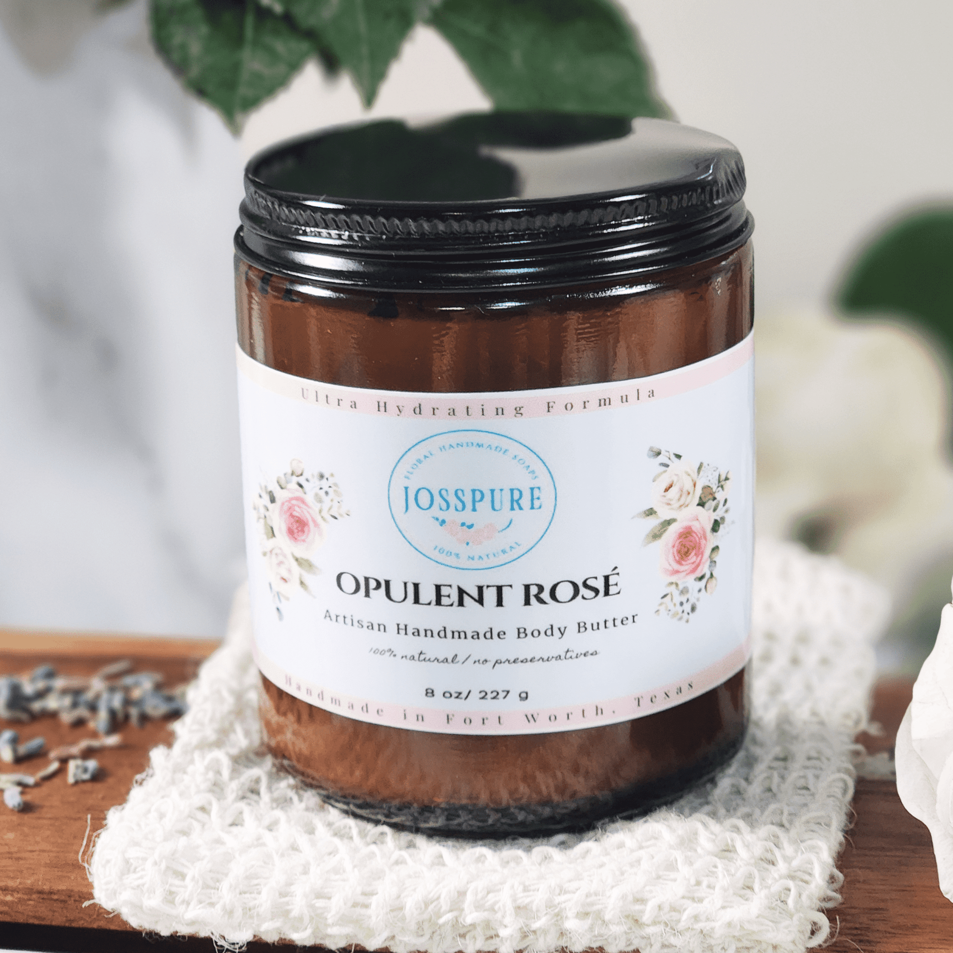 JOSSPURE rose mango butter whipped body butter in brown jar with floral label on white cloth