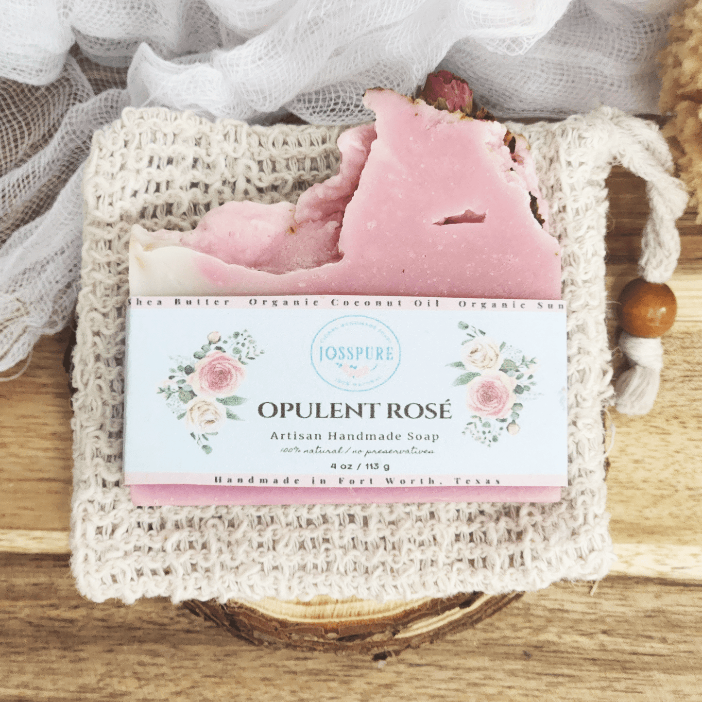 JOSSPURE rose mild shea butter soap bar with pink color and floral label on natural textured cloth
