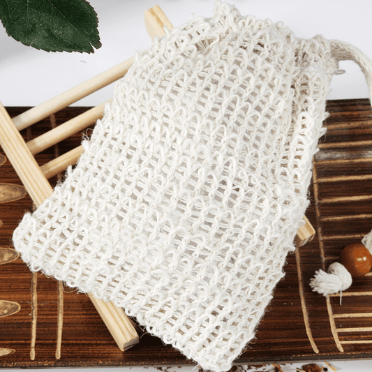 JOSSPURE soap saver and sisal bag for soap on wooden surface with green leaf background